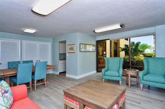 8779 Midnight Pass Rd Unit 406H, Sarasota, FL 34242 - living area featuring wood tiled floors and baseboards