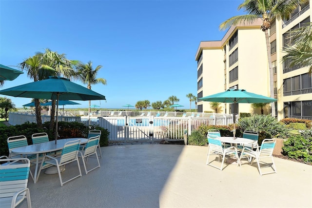 8779 Midnight Pass Rd Unit 406H, Sarasota, FL 34242 - view of patio / terrace with outdoor dining area and a community pool