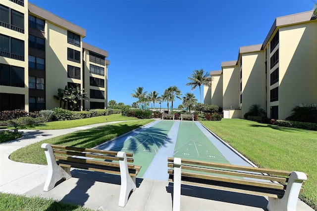 8779 Midnight Pass Rd Unit 406H, Sarasota, FL 34242 - view of community featuring a lawn and shuffleboard