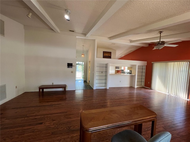 living area with vaulted ceiling with beams, visible vents, ceiling fan, a textured ceiling, and wood finished floors