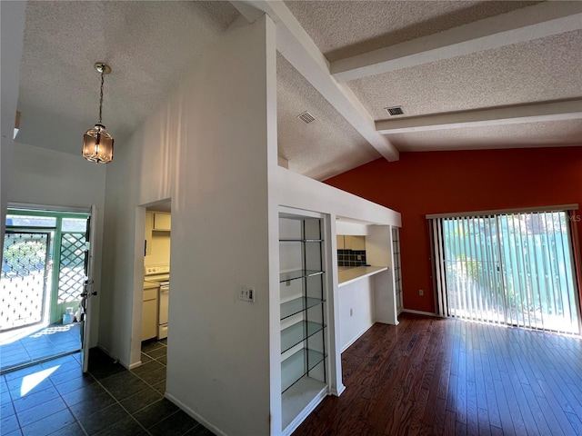 interior space featuring plenty of natural light, dark wood finished floors, visible vents, and vaulted ceiling with beams