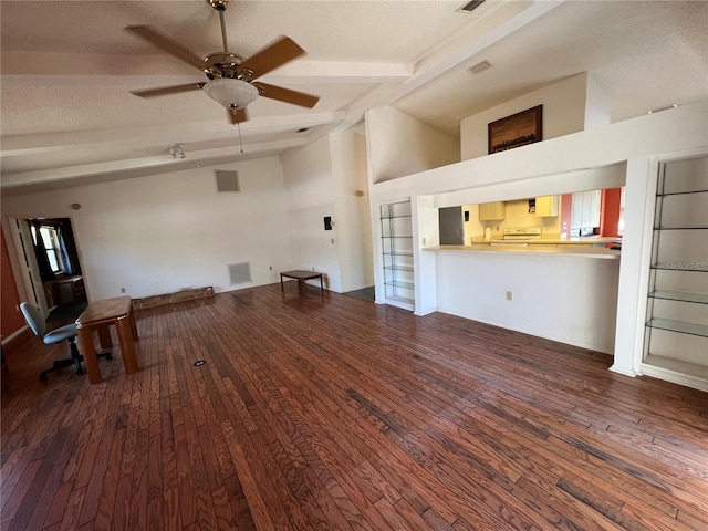 unfurnished living room featuring visible vents, a ceiling fan, lofted ceiling with beams, hardwood / wood-style flooring, and a textured ceiling