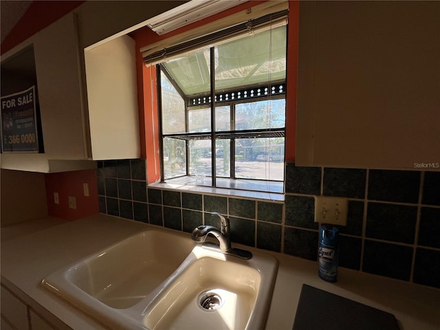 interior space with light countertops and a sink