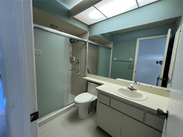 bathroom with toilet, a stall shower, tile patterned floors, and vanity