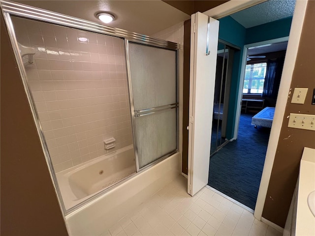 bathroom with enclosed tub / shower combo, vanity, and tile patterned floors