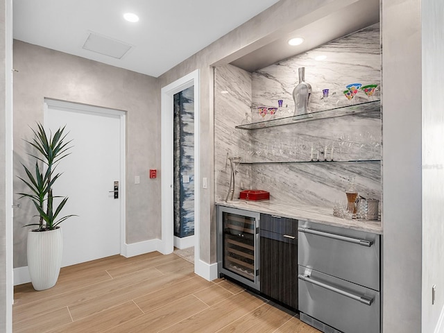 bar featuring beverage cooler, a dry bar, recessed lighting, light wood-style floors, and a warming drawer