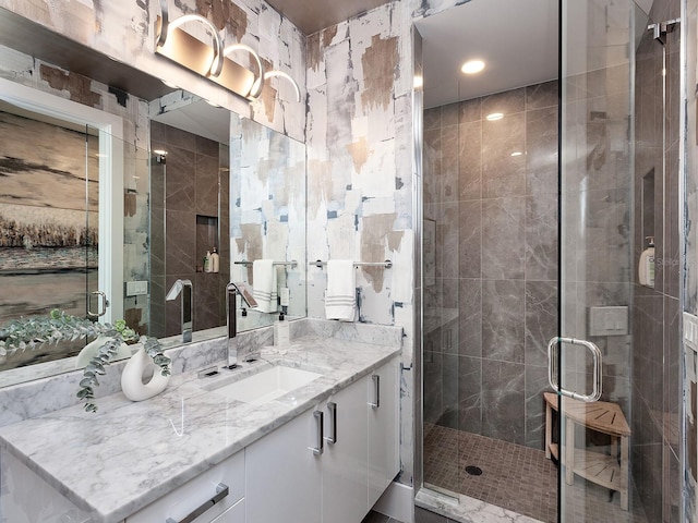 full bathroom featuring a stall shower and vanity