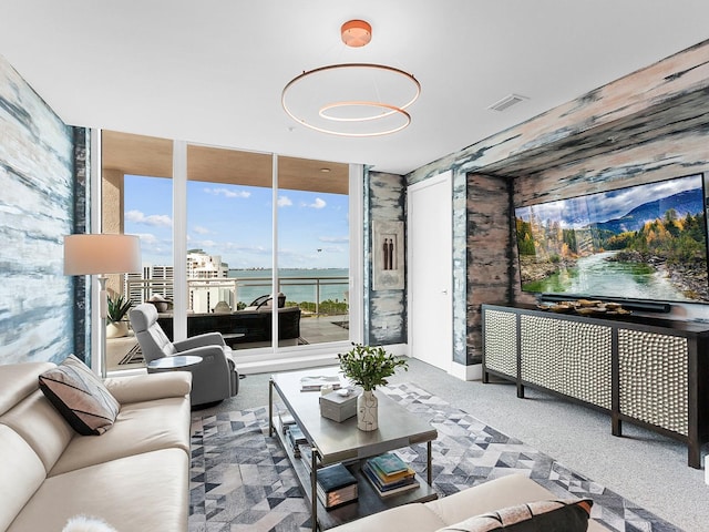 living area featuring floor to ceiling windows and visible vents