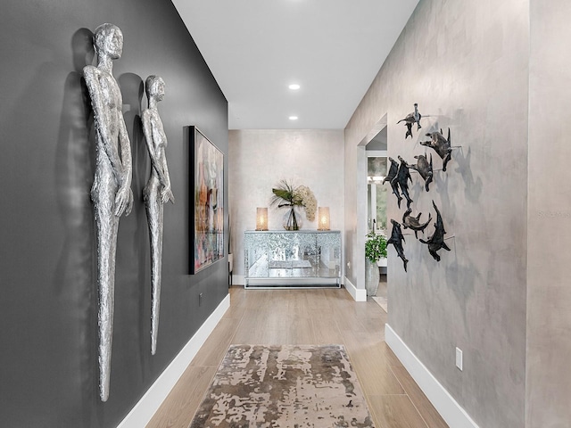 hallway featuring recessed lighting, baseboards, and wood finished floors