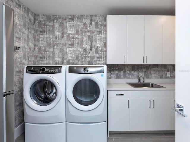 laundry area with a sink and washer and dryer