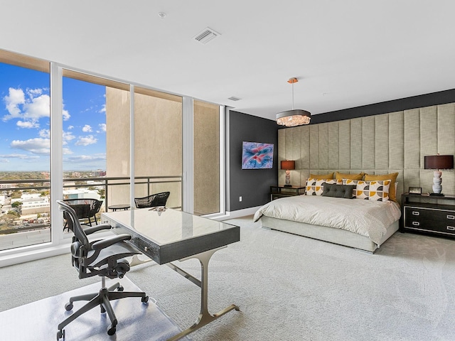 carpeted bedroom with visible vents, baseboards, and expansive windows