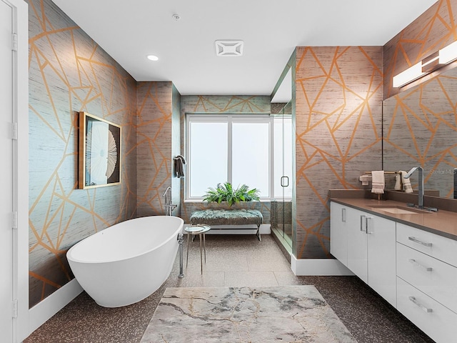 bathroom with recessed lighting, a freestanding tub, a shower stall, and vanity