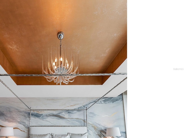 interior details featuring an inviting chandelier