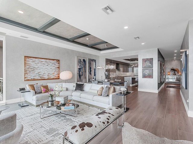 living room with recessed lighting, visible vents, baseboards, and wood finished floors