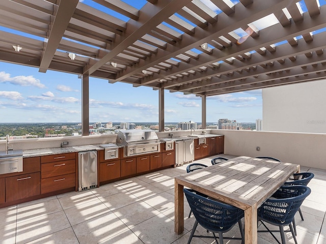 view of patio / terrace with a city view, area for grilling, a pergola, and a grill