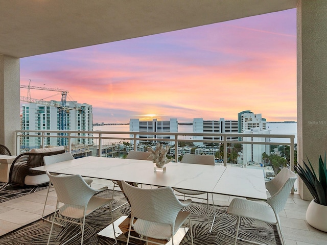 balcony at dusk with a view of city