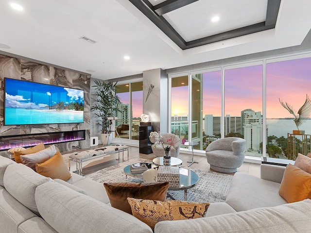 living area featuring recessed lighting, visible vents, a fireplace, and floor to ceiling windows