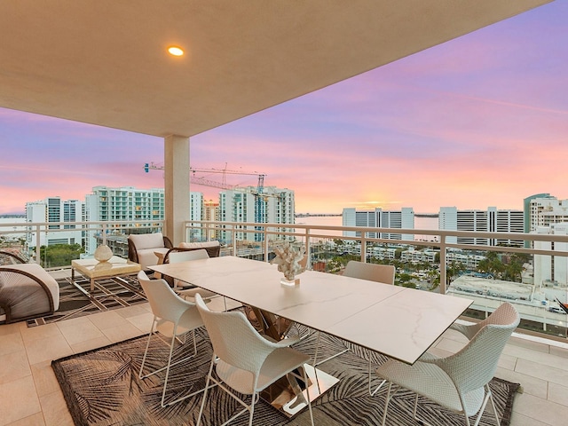 balcony at dusk with a view of city