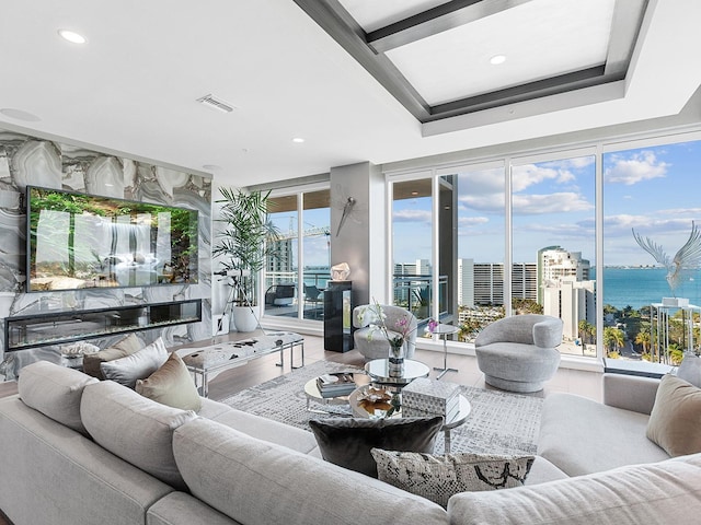 living area featuring a view of city, recessed lighting, wood finished floors, and visible vents