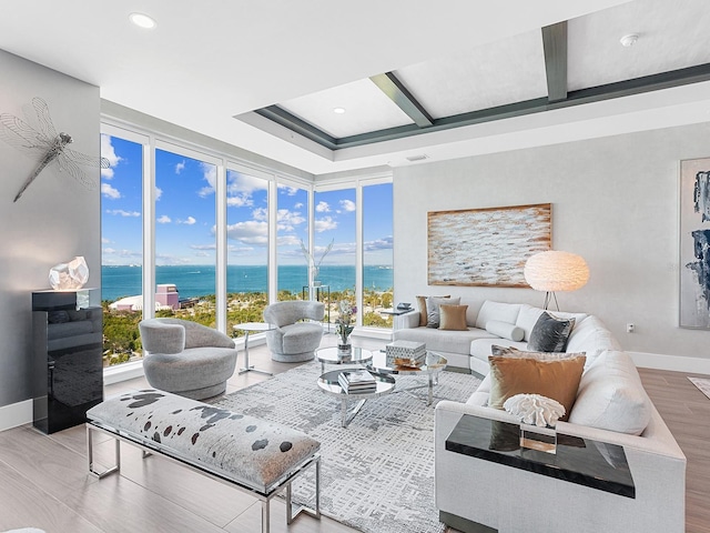 living room featuring wood finished floors, baseboards, coffered ceiling, a water view, and beamed ceiling