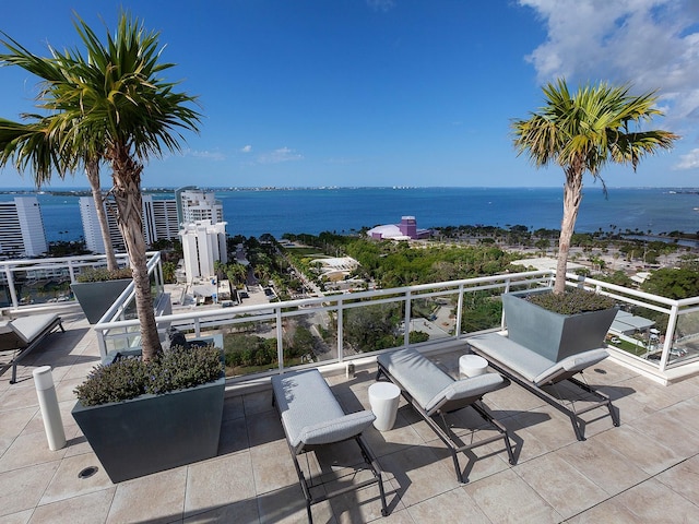 view of patio / terrace featuring a balcony and a water view