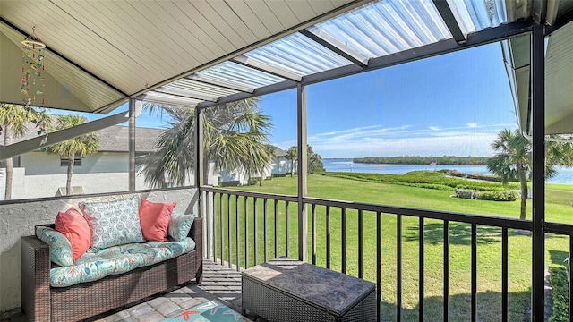 sunroom / solarium featuring a healthy amount of sunlight and a water view