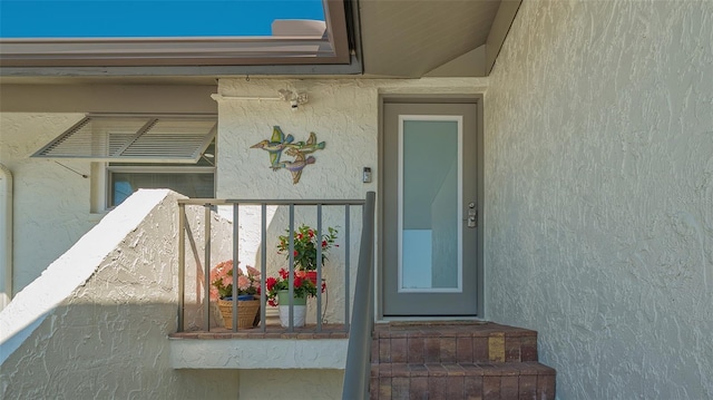 doorway to property with stucco siding