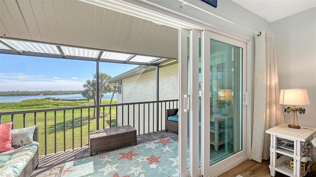 sunroom / solarium featuring a water view