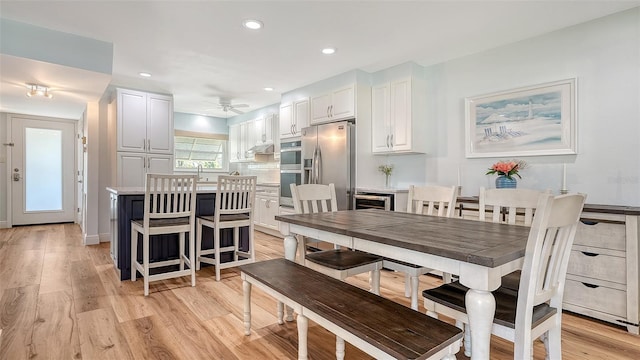 kitchen with stainless steel appliances, white cabinets, a center island, and light countertops