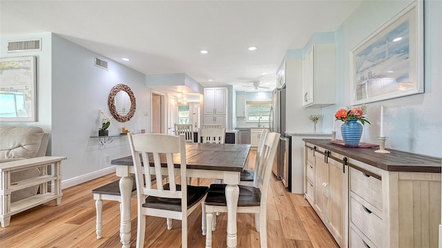 dining area with recessed lighting, visible vents, and light wood-style flooring