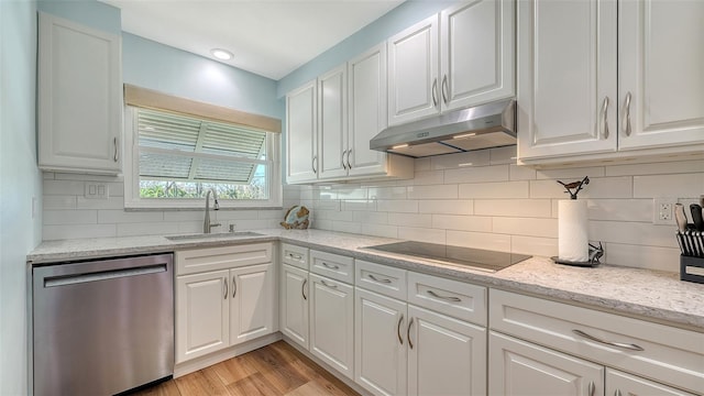 kitchen with a sink, white cabinets, under cabinet range hood, dishwasher, and black electric cooktop