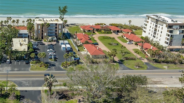 birds eye view of property featuring a view of the beach and a water view