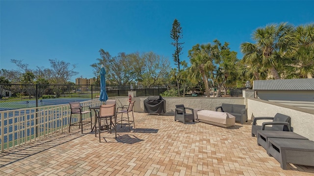 view of patio featuring area for grilling and fence