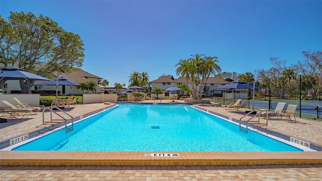 pool featuring a patio area and fence