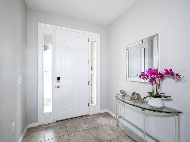 entryway featuring light tile patterned floors and baseboards