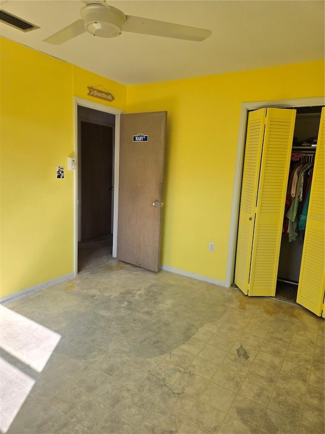 unfurnished bedroom with baseboards, visible vents, a closet, and tile patterned floors