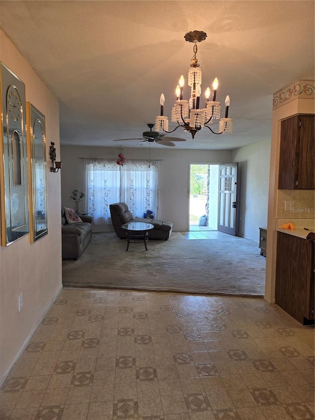 unfurnished dining area with a textured ceiling and ceiling fan with notable chandelier