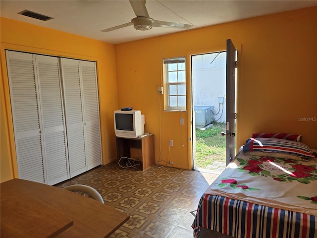 bedroom featuring a ceiling fan, visible vents, access to outside, a closet, and tile patterned floors