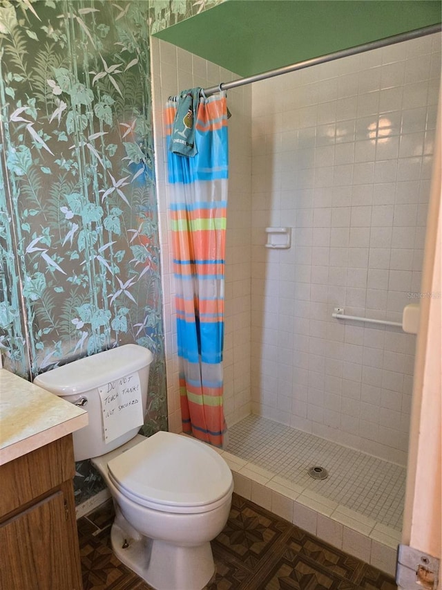 full bath featuring vanity, a shower stall, toilet, and wallpapered walls