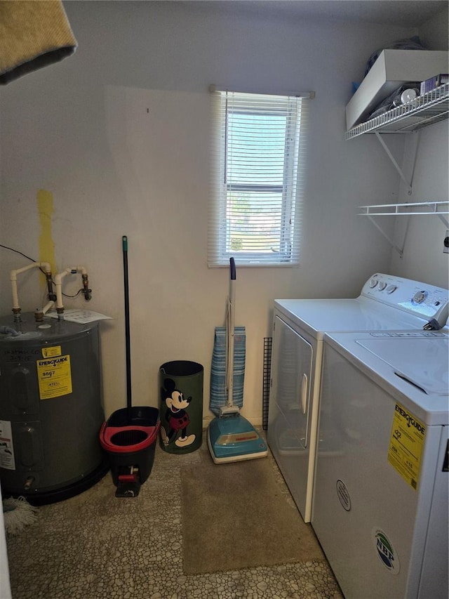 laundry room with laundry area, water heater, and independent washer and dryer