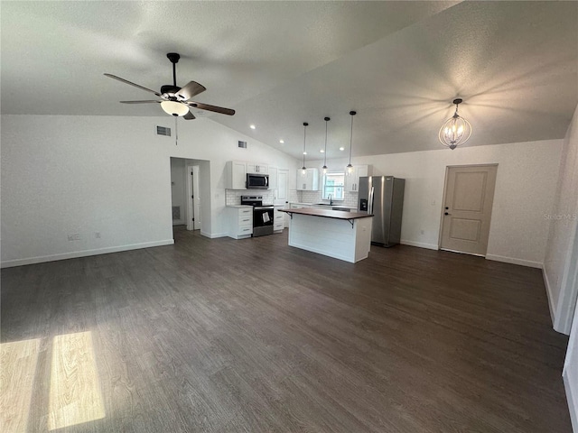 kitchen with open floor plan, appliances with stainless steel finishes, visible vents, and lofted ceiling
