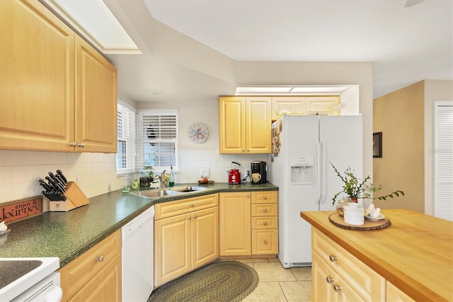 kitchen featuring decorative backsplash, light tile patterned flooring, a sink, light brown cabinets, and white appliances