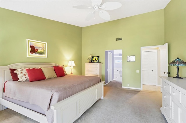 bedroom featuring light carpet, ceiling fan, a towering ceiling, and baseboards