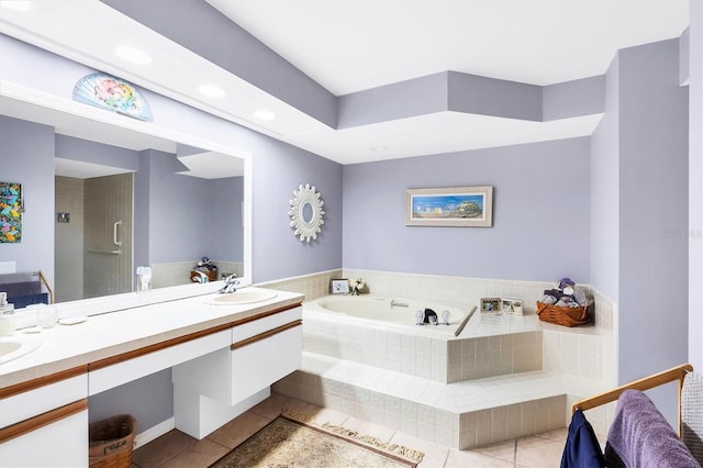 bathroom with tile patterned flooring, a sink, a bath, and double vanity