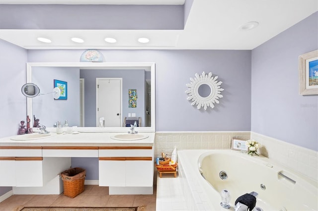 bathroom featuring tile patterned flooring, a sink, a jetted tub, and double vanity