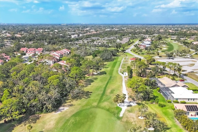 drone / aerial view featuring view of golf course and a residential view