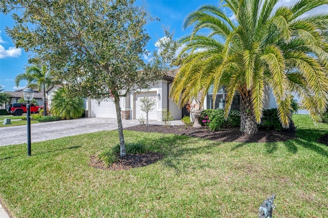 view of property hidden behind natural elements with a garage, stucco siding, decorative driveway, and a front yard