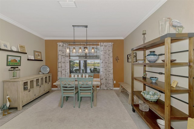 dining room with light tile patterned floors, baseboards, visible vents, and crown molding