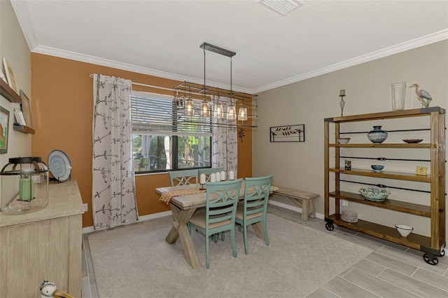 dining room featuring ornamental molding, visible vents, and baseboards