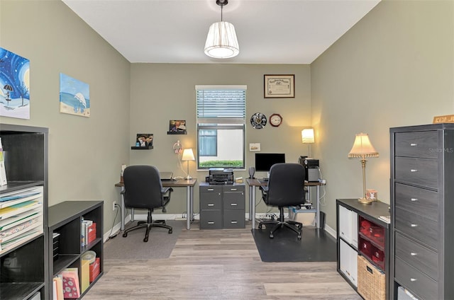 home office with baseboards and wood finished floors